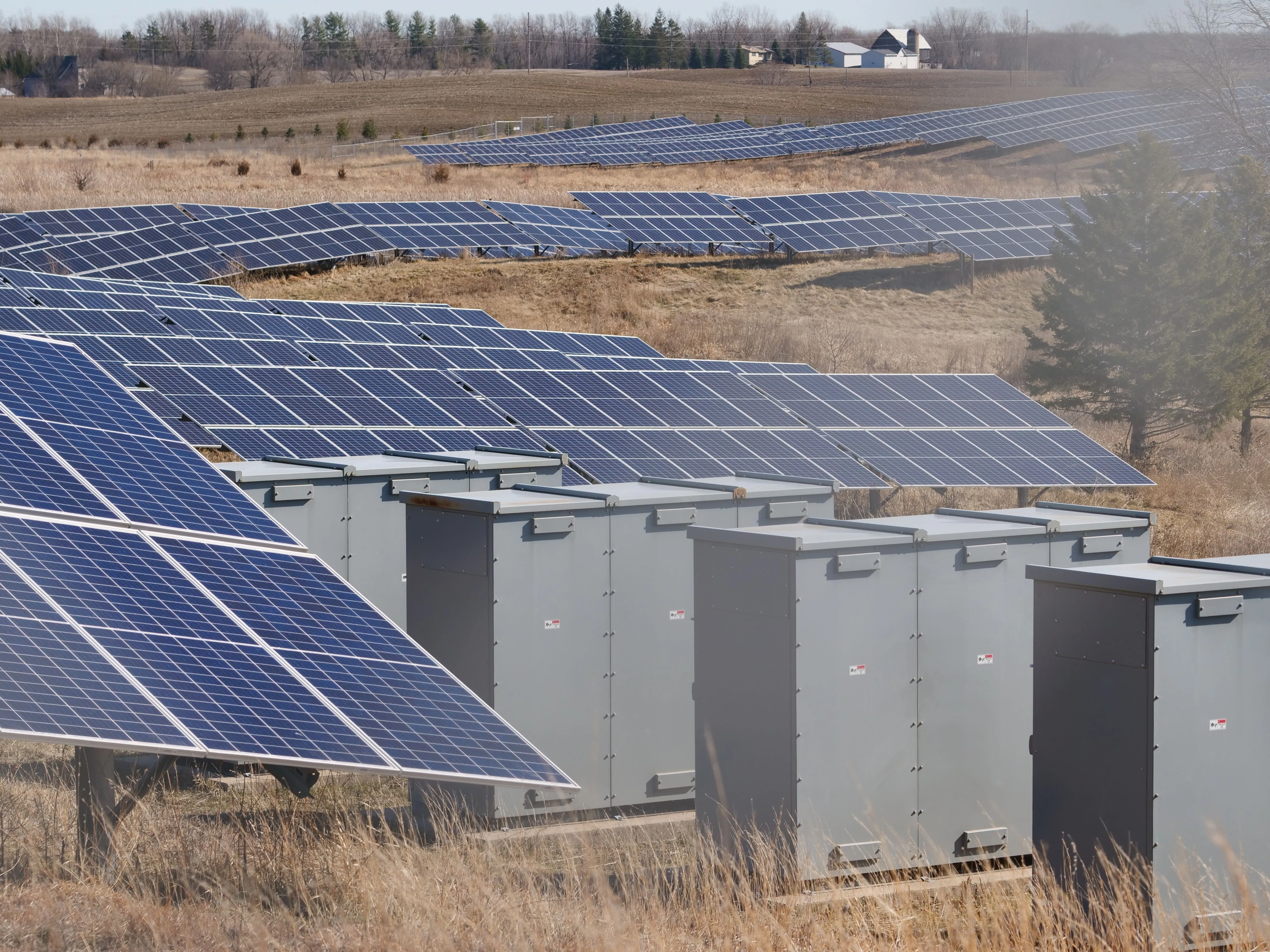 Battery cabinets installed beside a solar farm